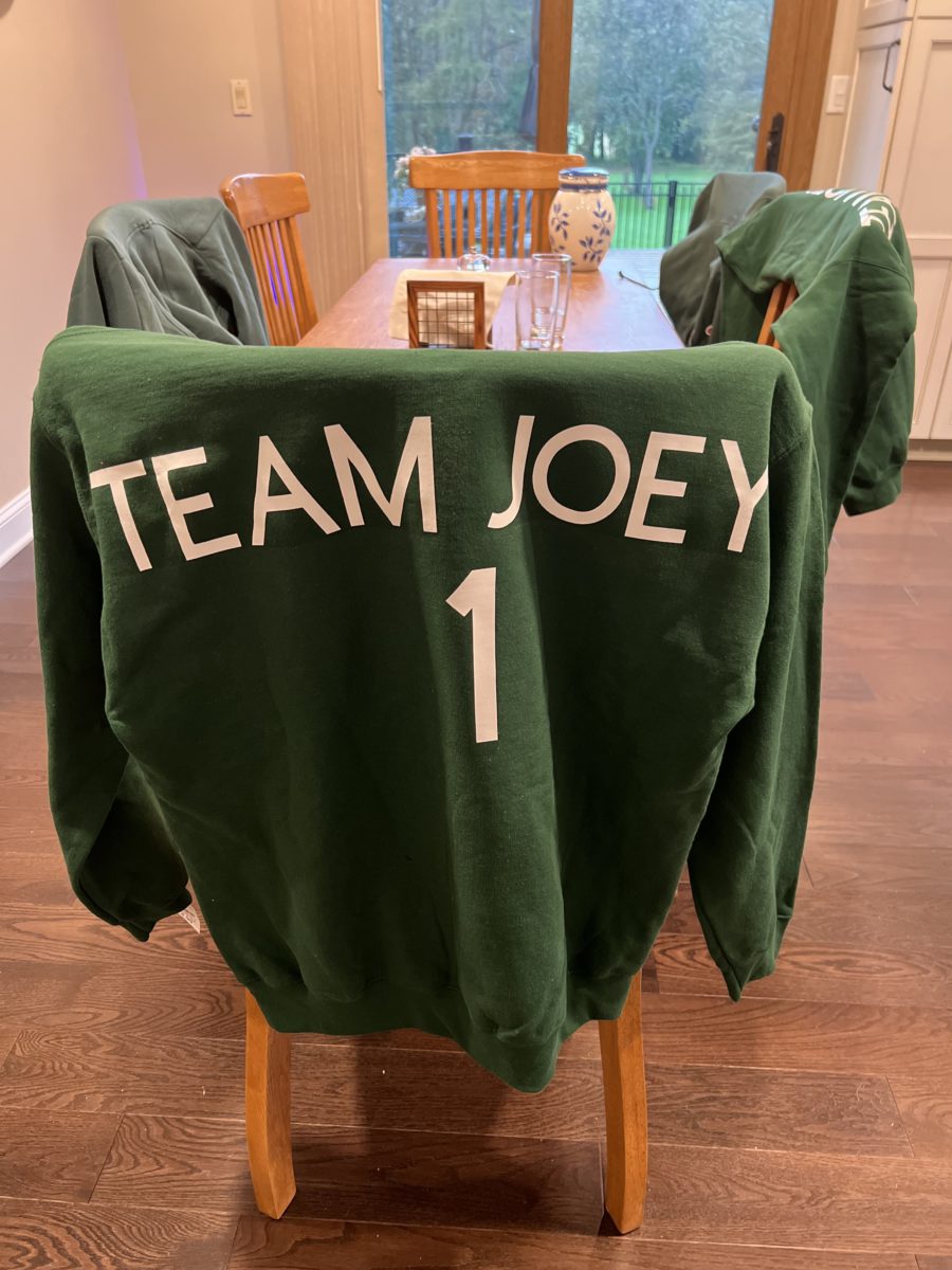 Team Joey Sweatshirt over a chair in the dining room.